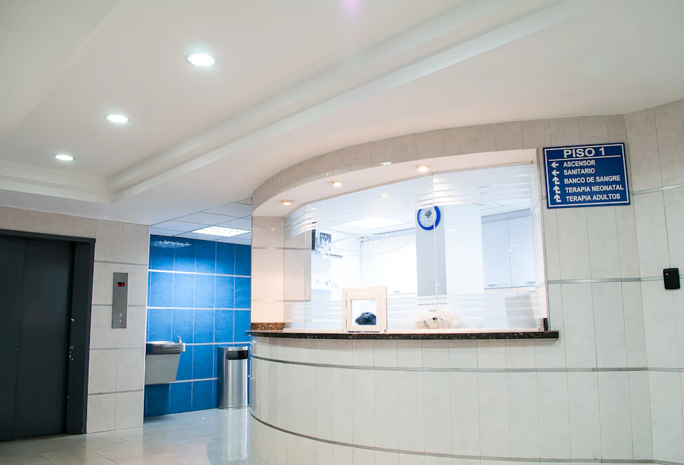 Bright hospital corridor with natural light and indoor plants